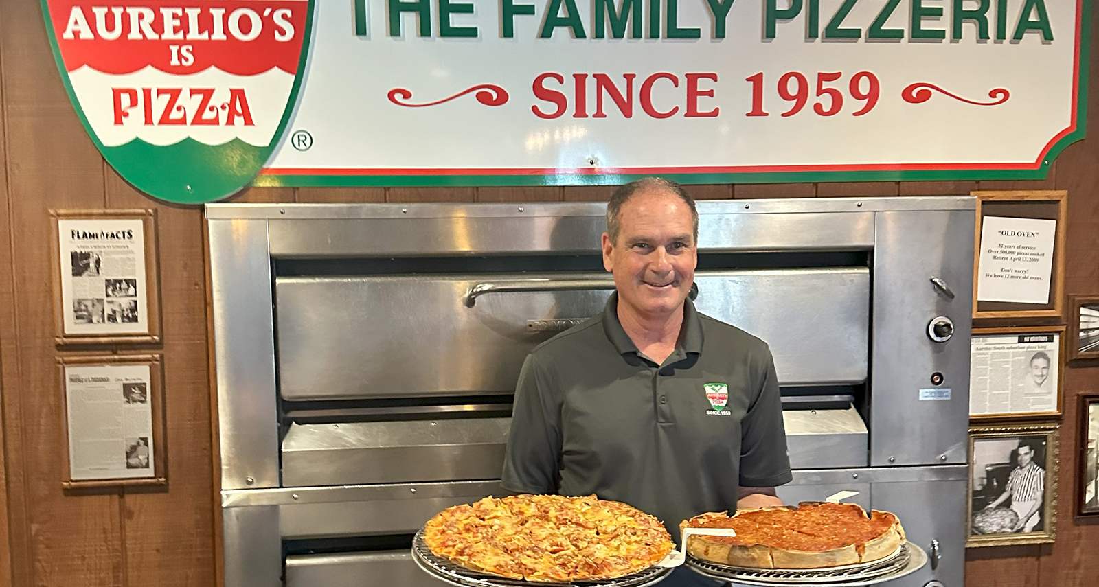 Joe Aurelio in a polo holding a Poperoni pizza and a deep dish pizza in front of the Aurelios logo